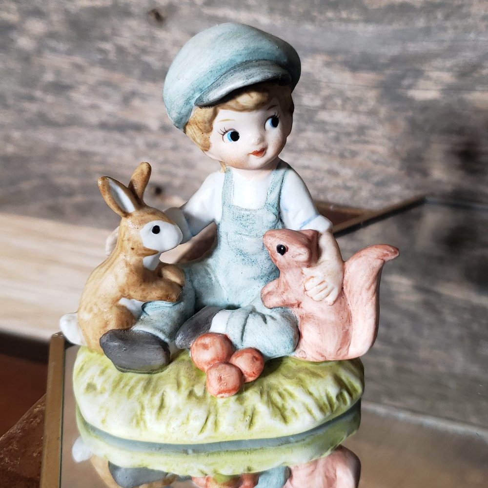 Boy with bunny & squirrel sitting on grass Figurine  by Lefton China Exclusives